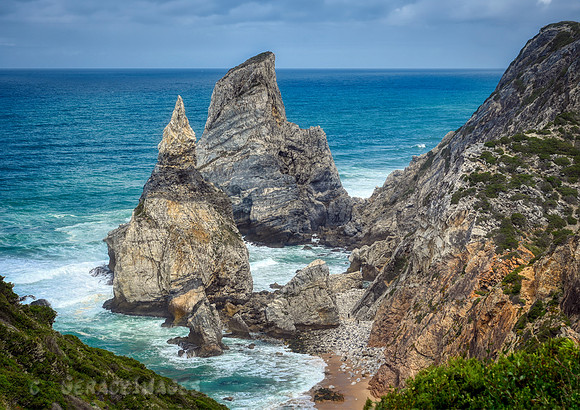 You can see how massive the rock formations are compared to the people walking along the beach below