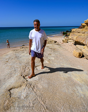 Walking amongst the dinosaur footprints at Salema Beach