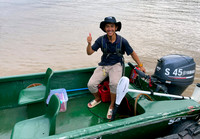 Our boatsman Saipul and our boat with additional electric motor.